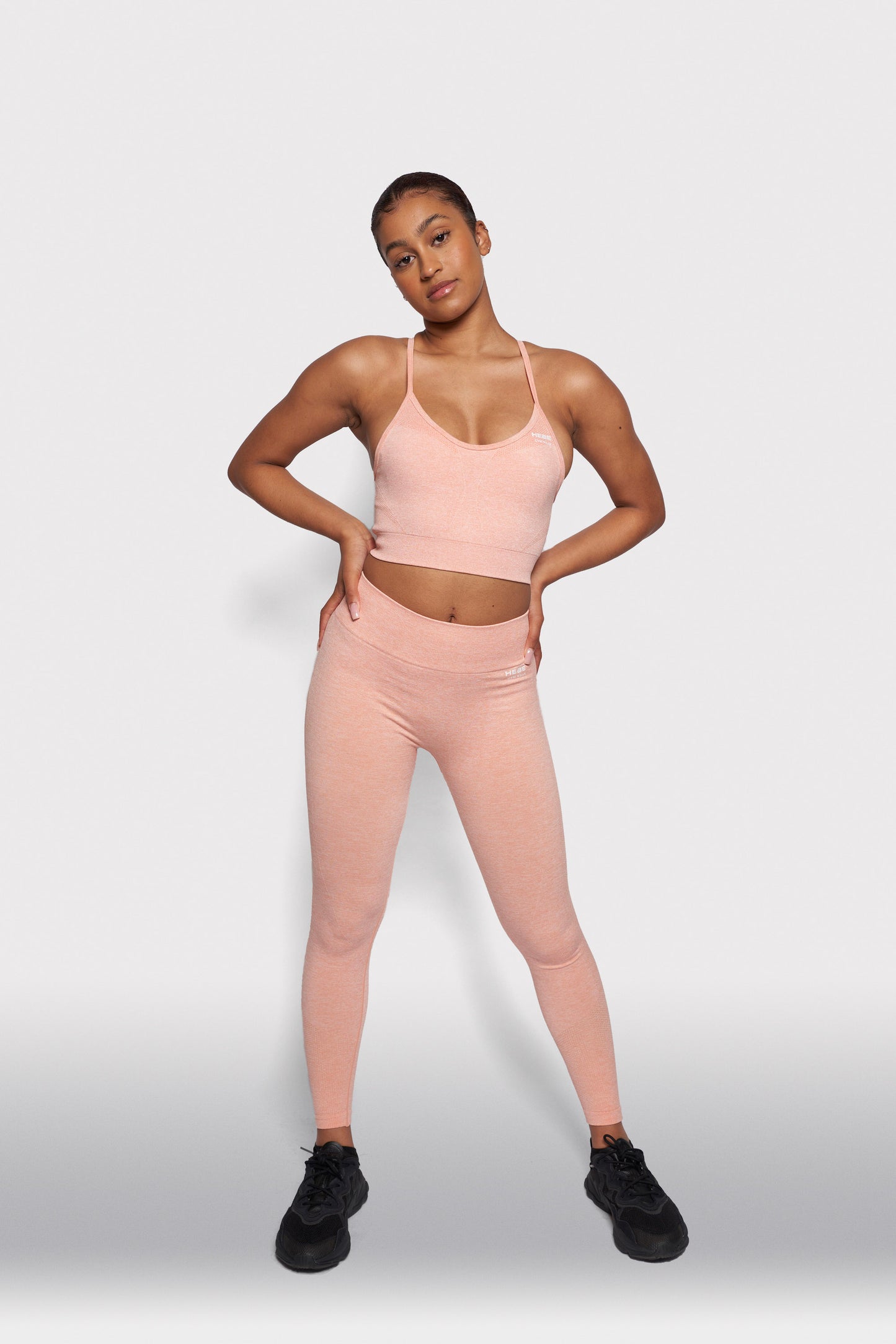 girl in peach coloured bra top and leggings gymwear set