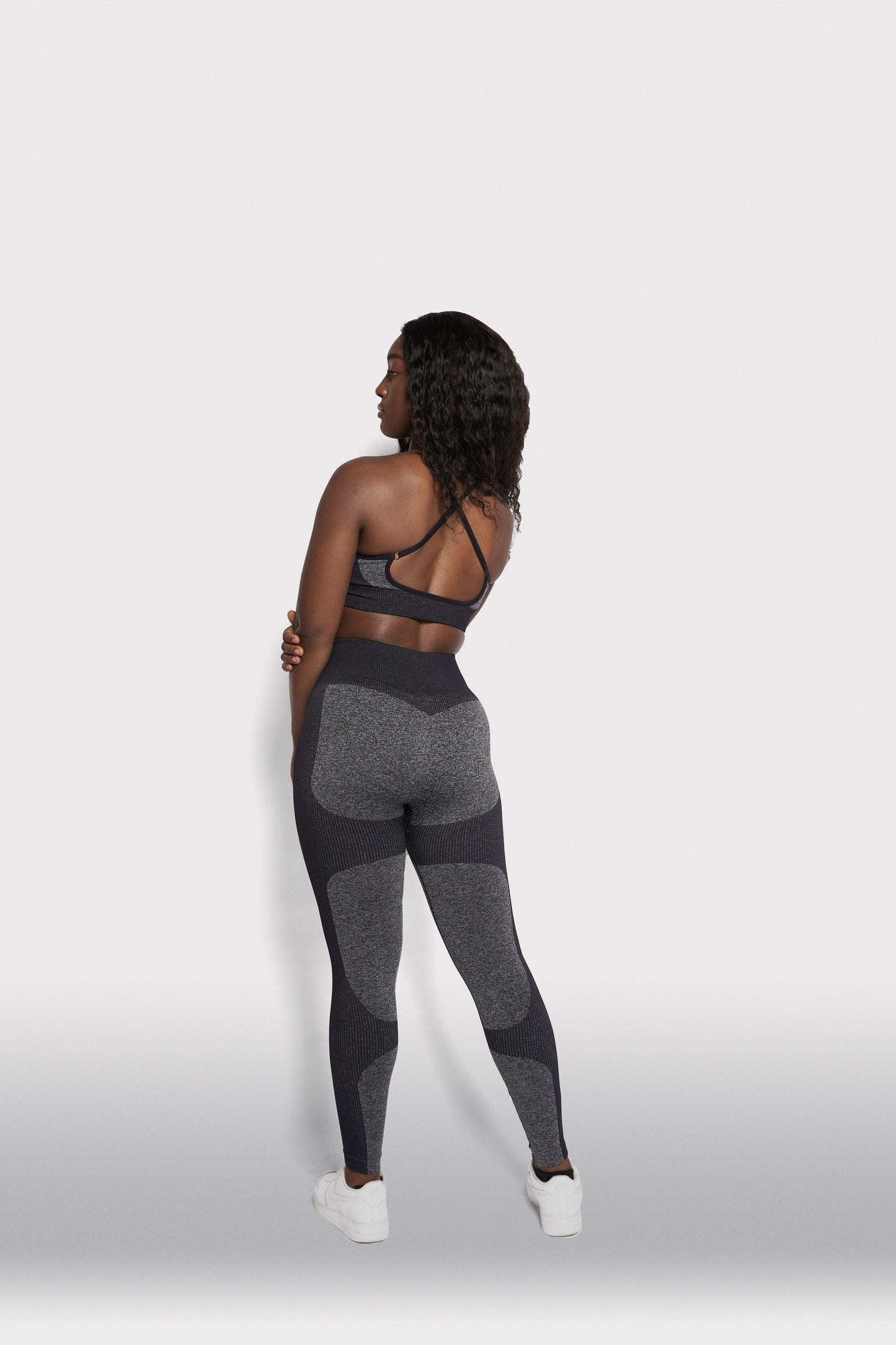 back view of girl wearing grey gymwear outfitt