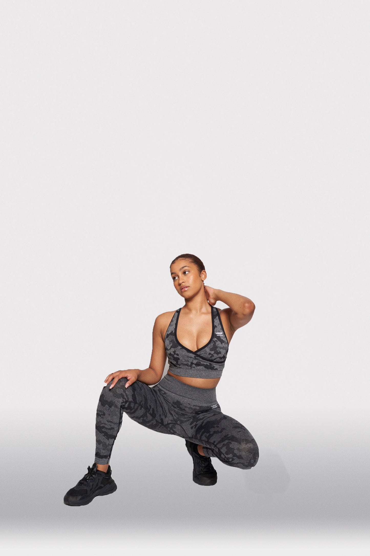 model posing in grey camouflage bra top and matching leggings